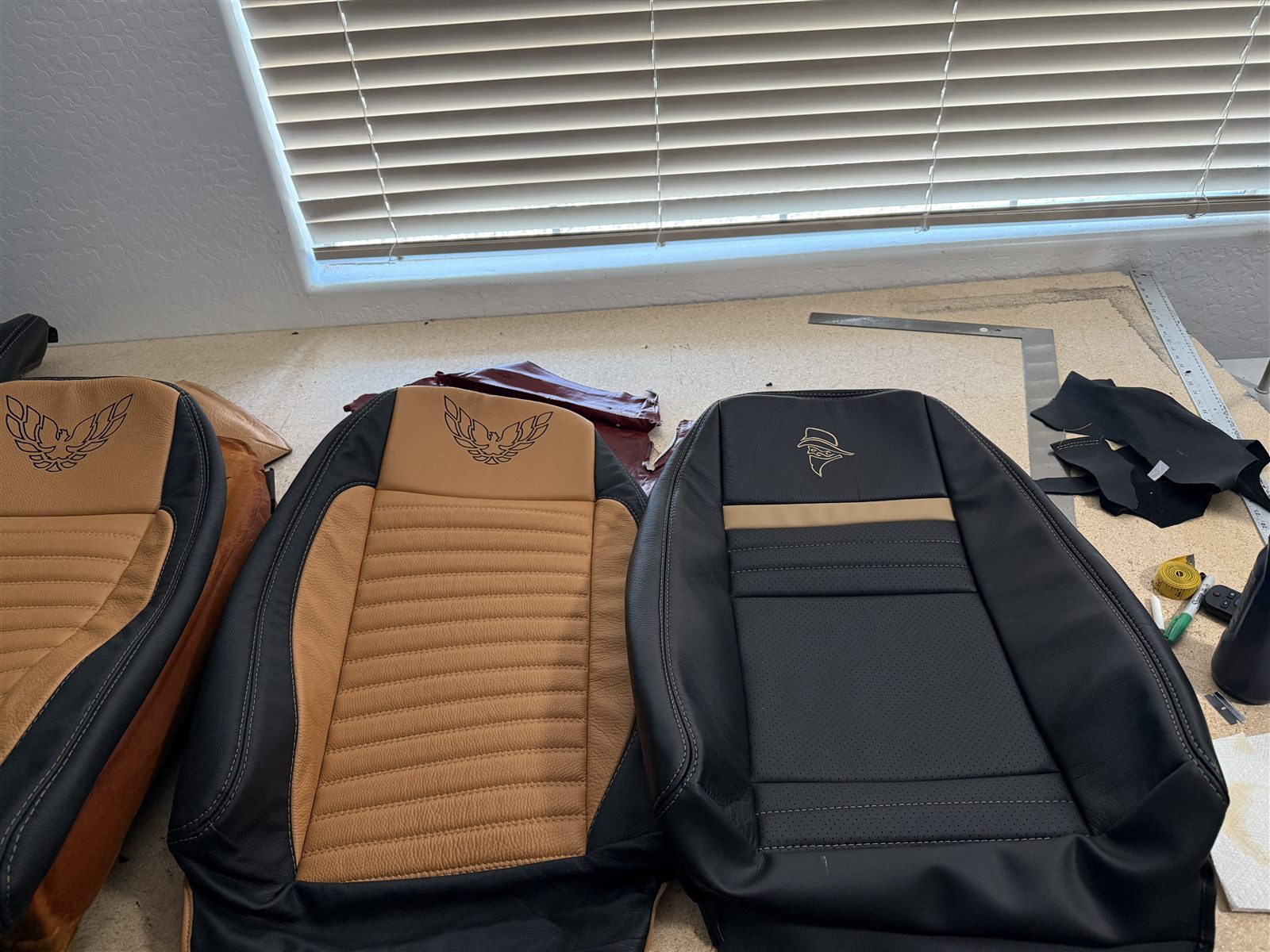 Three custom Trans Am seat covers showing Firebird and Bandit embroidery options