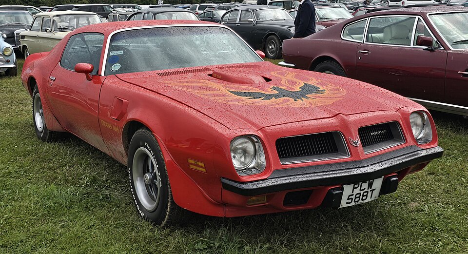 Red 1974 Pontiac Firebird Trans Am with hood bird decal and shaker scoop
